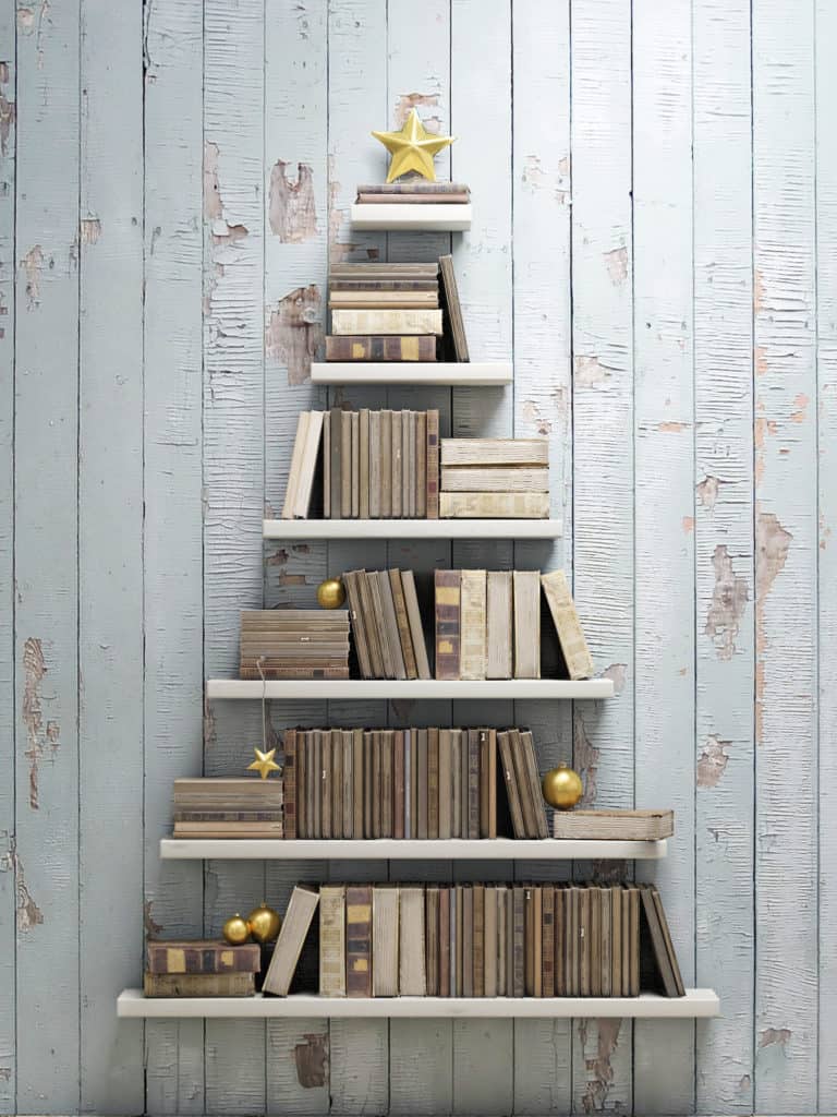 shelves and books arranged in the shape of a christmas tree with a star at the top