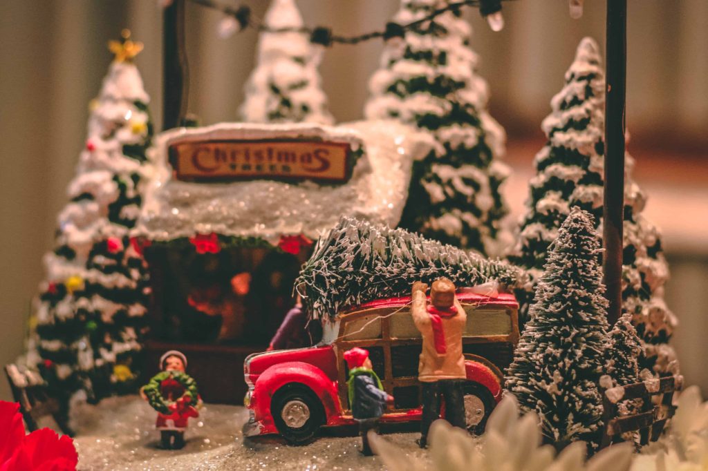 figurines of christmas tree lot with red truck