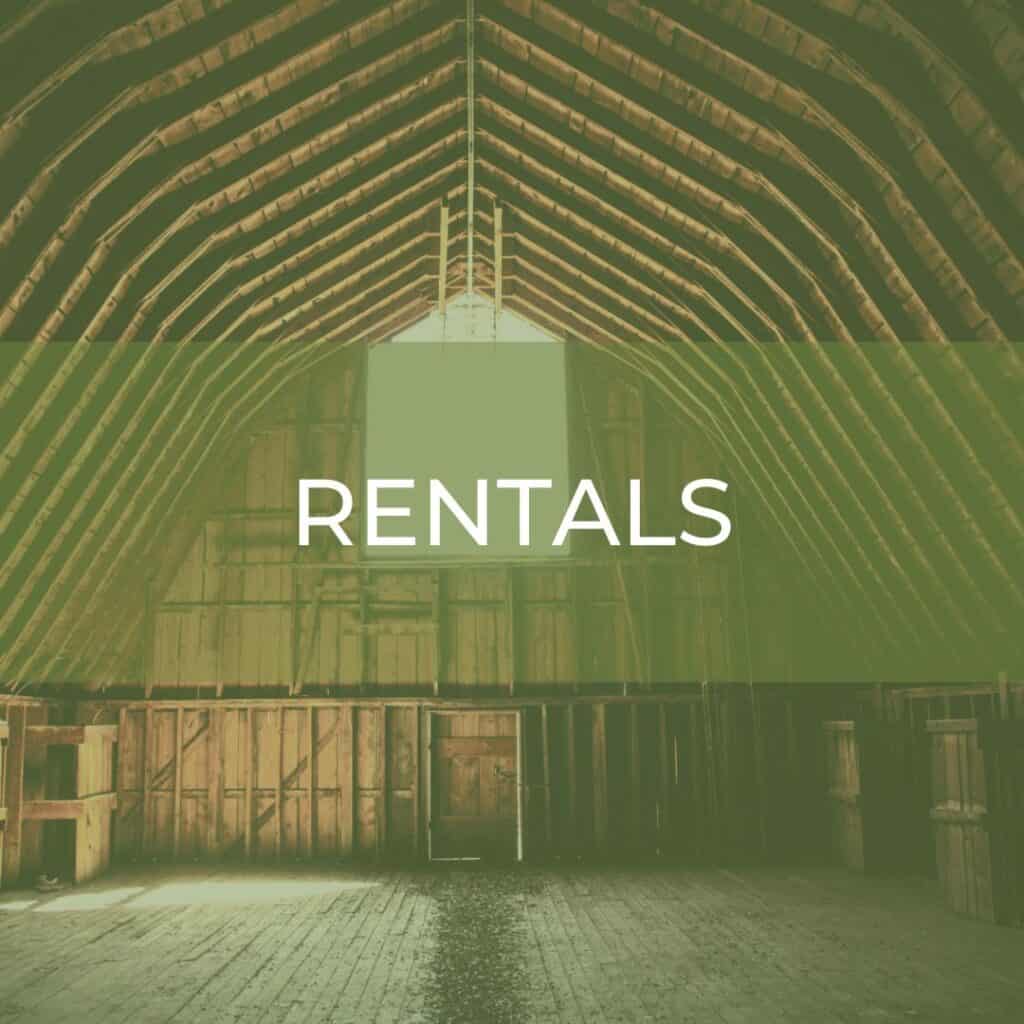 text overlay of the word rentals over an image of an empty wooden barn